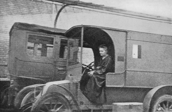 Marie Curie sitting in a mobile X-ray vehicle, c. 1915, during World War I.