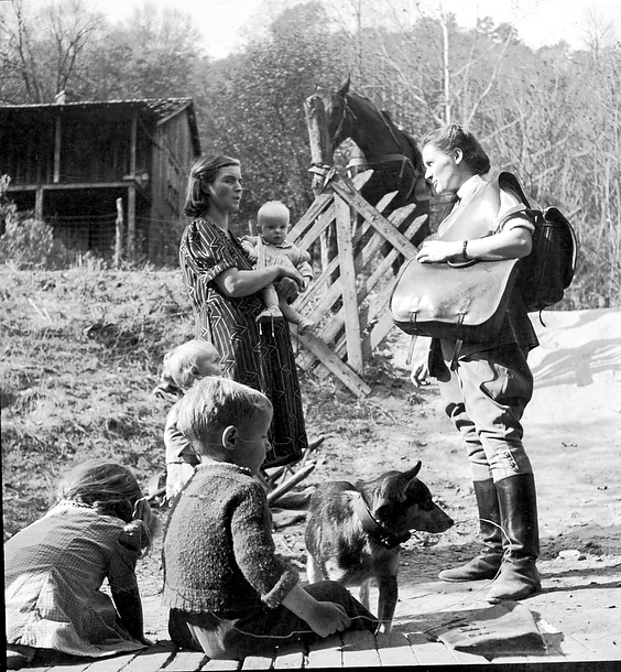 Mary Breckinridge speaking with a mother and her children during a home visit, Frontier Nursing Service.