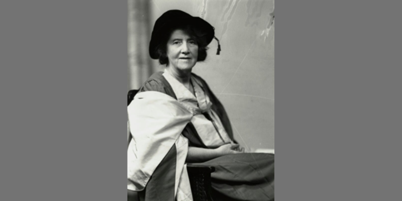 Black and white photograph of Marie Charlotte Carmichael Stopes wearing academic regalia, symbolizing her scholarly achievements in science and women's health advocacy.