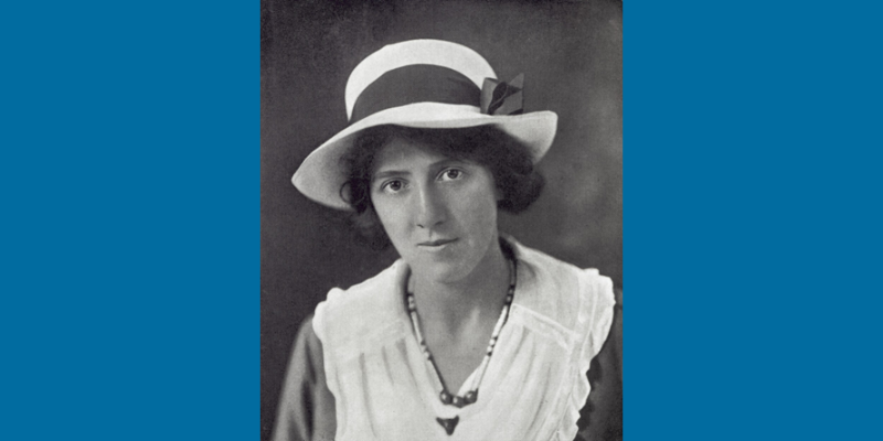 Black and white portrait of Marie Charlotte Carmichael Stopes wearing a stylish hat and necklace, reflecting early 20th-century fashion.